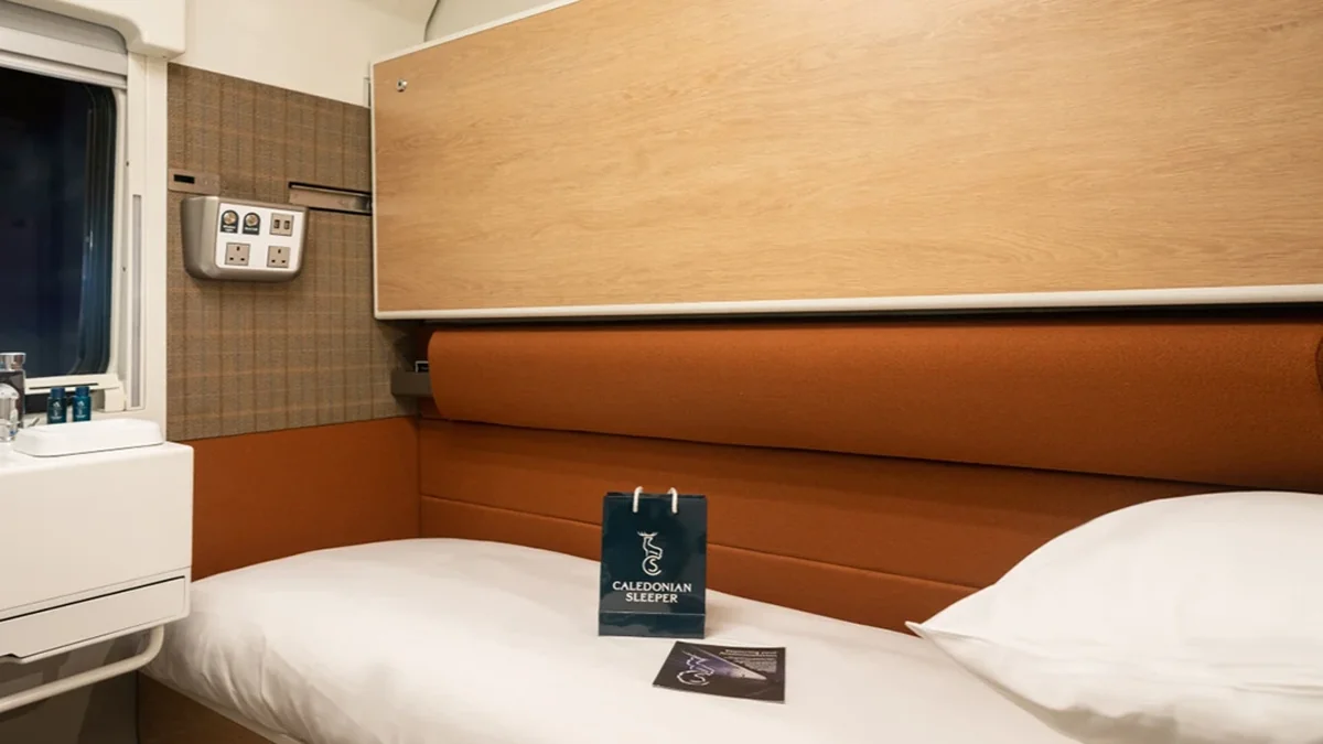 Caledonian Sleeper Classic Room berth with wood-panelled headboard and bedding